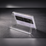 Clear acrylic tent-style card holder displaying a printed insert, designed for double-sided viewing on desks, counters, or reception areas