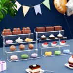 Clear acrylic tiered display stands showcasing assorted desserts including chocolates, cupcakes, and macarons, ideal for events, bakeries, and retail presentation