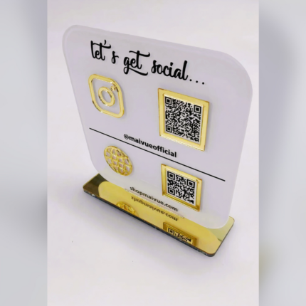 Frosted acrylic countertop display sign with gold accents featuring QR codes, Instagram branding, and website details, designed for easy customer interaction and social media access.