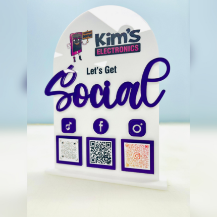 White acrylic countertop display sign with purple accents featuring a business logo, “Let’s Get Social” text, social media icons, and QR codes for TikTok, Facebook, and Instagram for easy customer engagement.